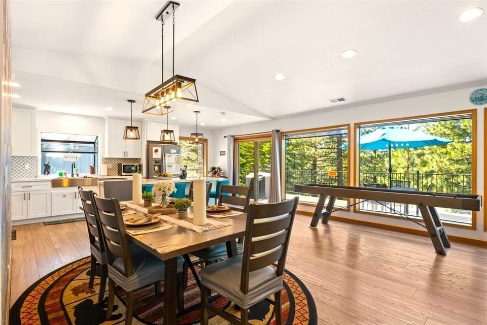 Gather for dinner while overlooking the game area and scenic deck, blending entertainment and mountain comfort in one inviting space.