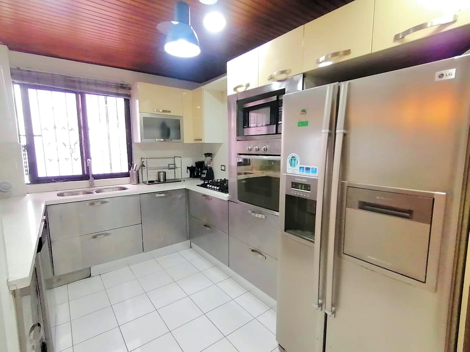 Fully equipped kitchen next to dining area.