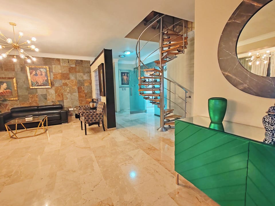 Main entrance to the apt connecting to living, dining, and staircase to 2nd lvl.