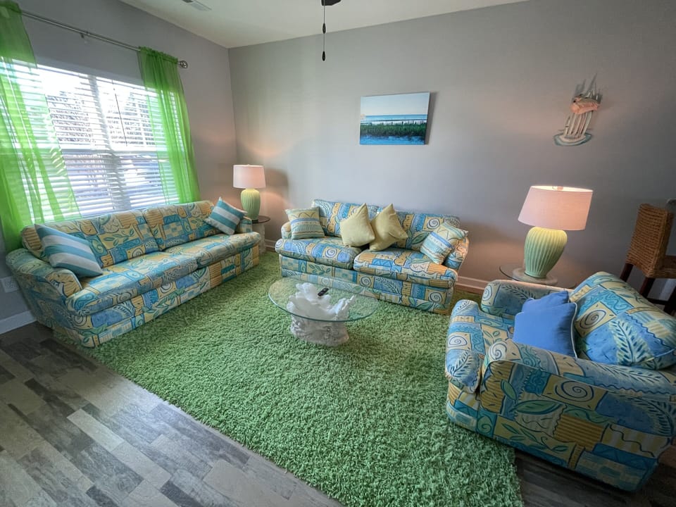 FUN AND BEACHY! Hang out in this Clutter free, cozy, bright colored living room.