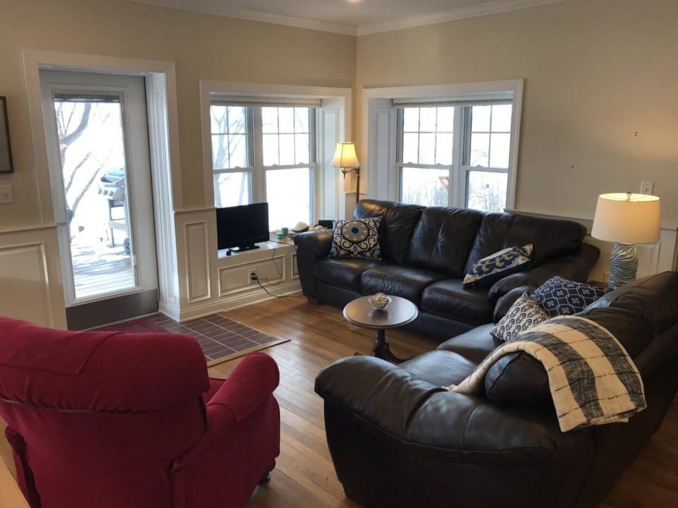 Cottage living room walks out to lakeside deck with a Weber gas grill