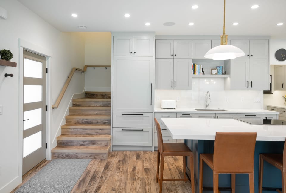 Sub Zero custom refrigerator to the right of the stairs.