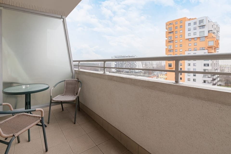 A spacious balcony with outdoor furniture, perfect for enjoying fresh air and city views.
