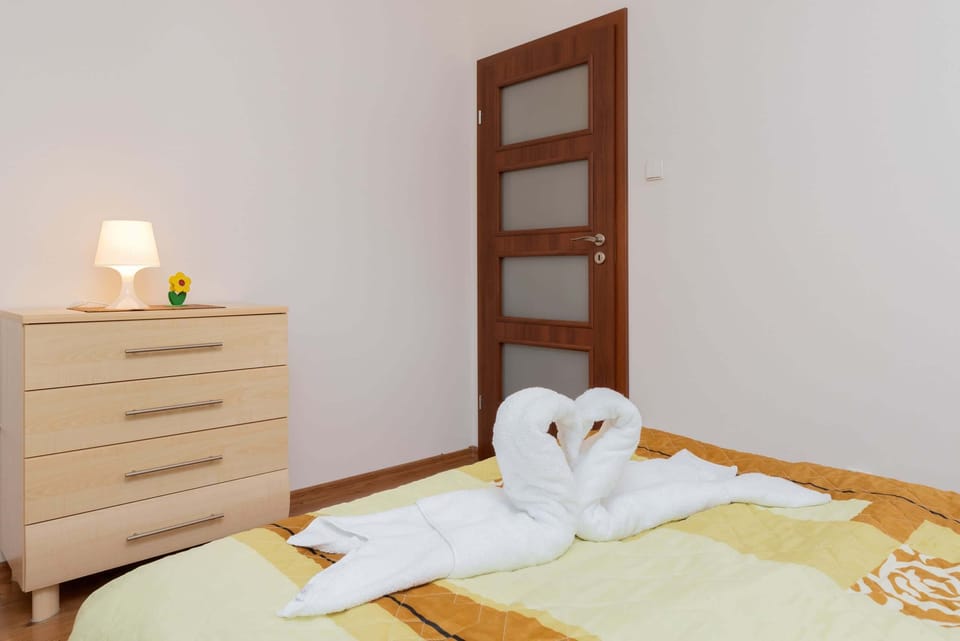 A close-up of a dresser and bedside lamp, adding a homey and practical touch to the room.
