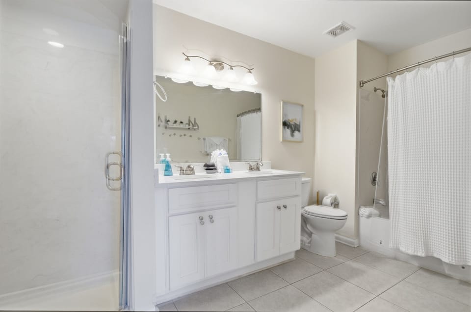 Master ensuite bathroom has his and her sinks & two showers! One stand-up and one shower/tub combo allowing two people to get ready in private!