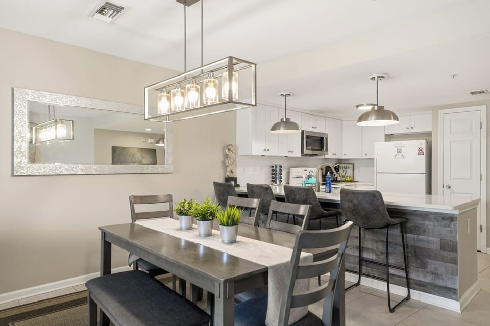 Enjoy meals together at the stylish dining table, with room for everyone and the kitchen just steps away.