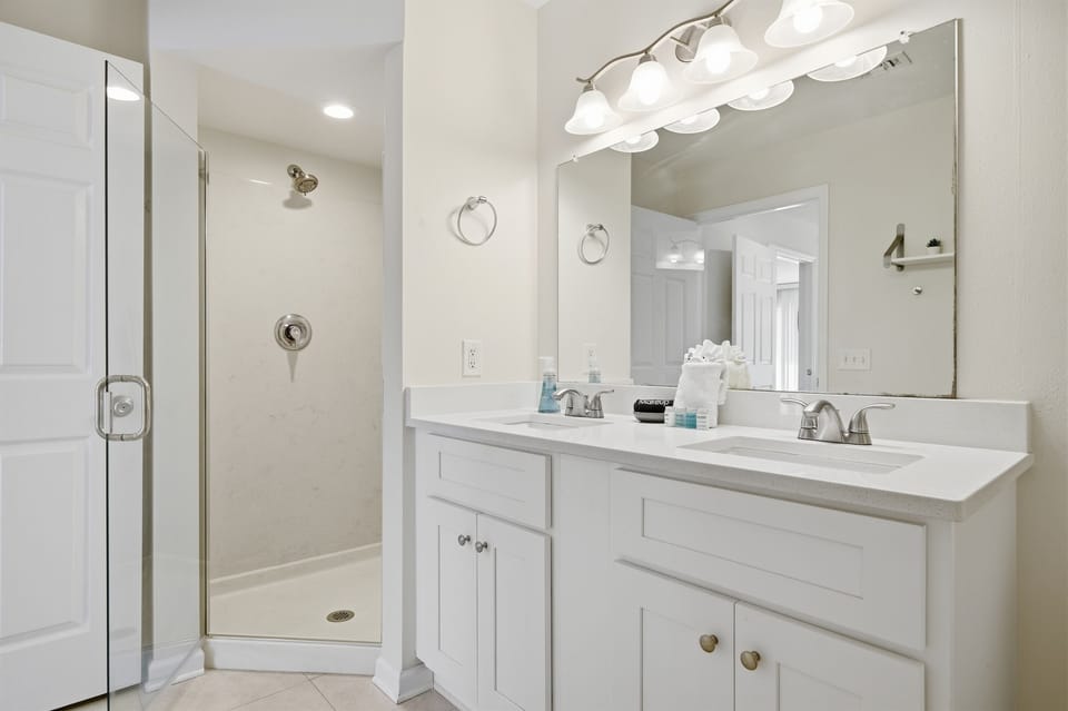 The primary bathroom features a walk-in shower and double sinks—perfect for getting ready with ease.