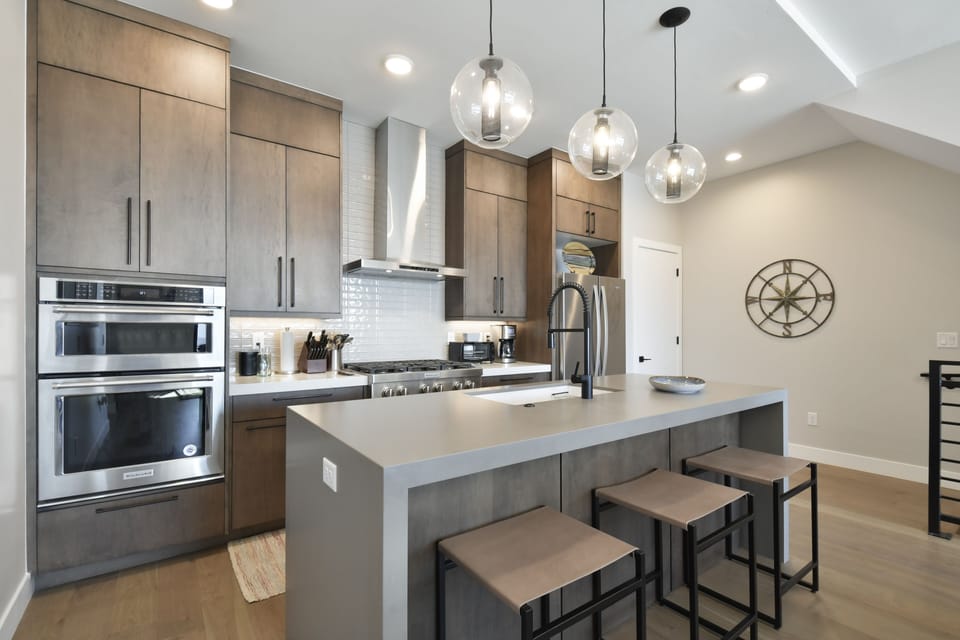 Chef's kitchen with sleek cabinetry, island seating, and premium finishes.