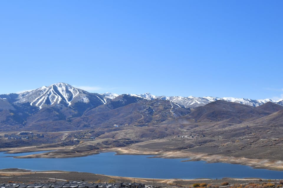 Unobstructed panorama of Jordanelle Reservoir and Deer Valley peaks.