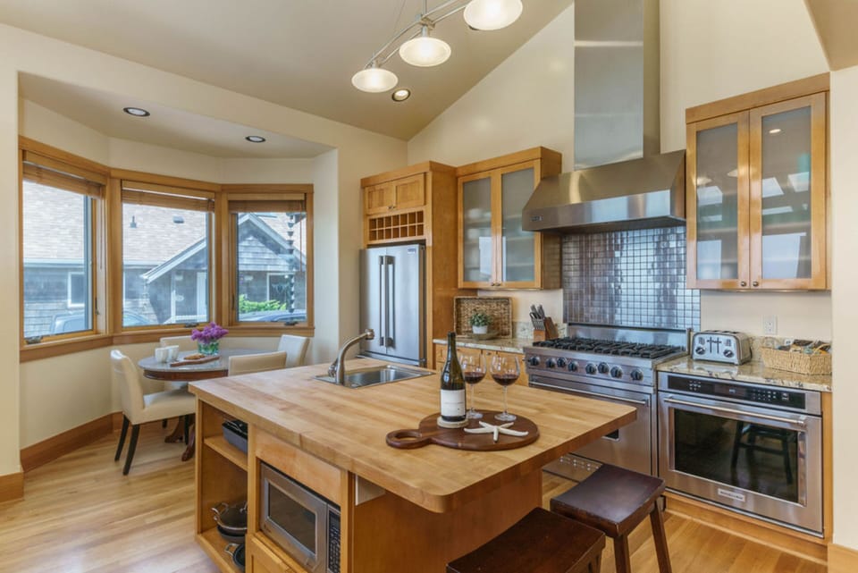 The large kitchen features modern appliances, an island, and a breakfast nook.