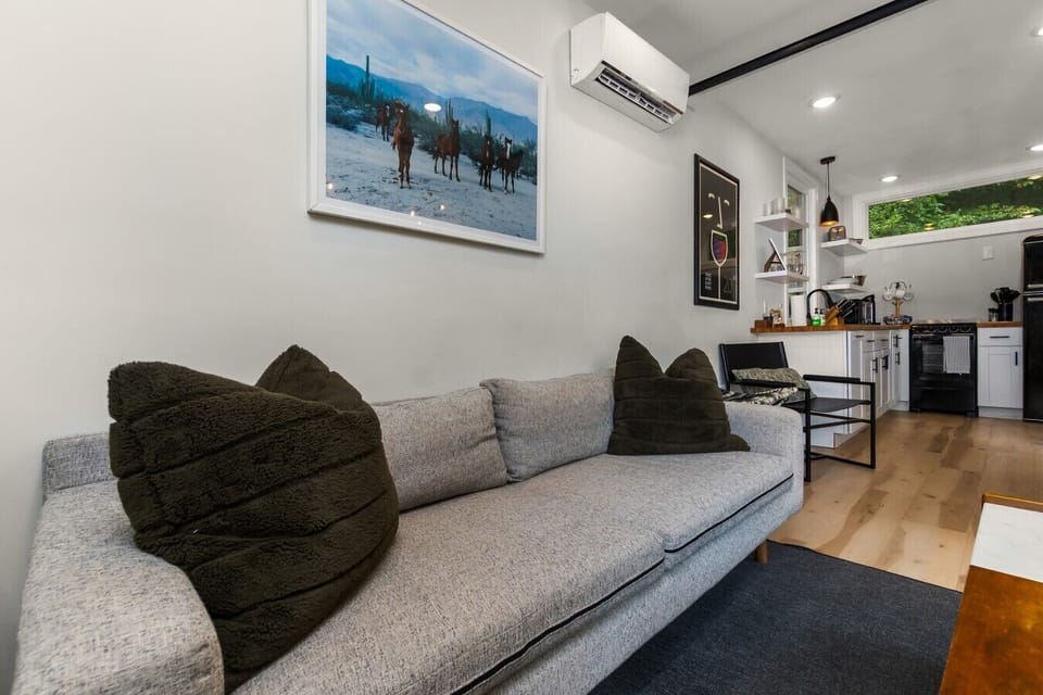 Settle into the comfortable living room after a day of exploring, with a TV, cozy seating, and the kitchen just steps away.