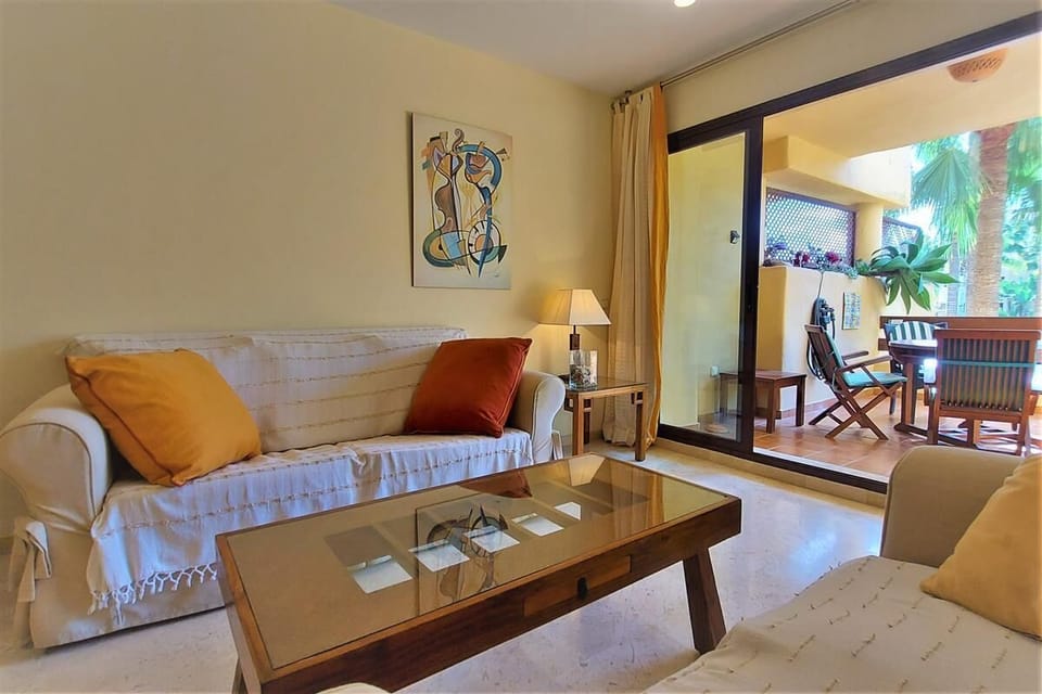 Lounge area with comfortable seating and access to the balcony