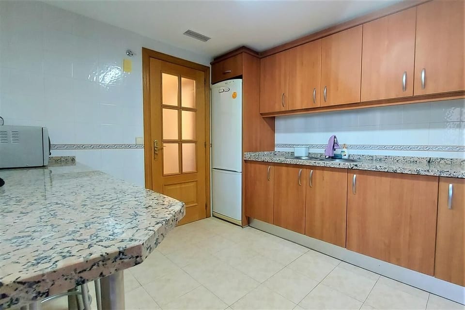Another view of the kitchen with breakfast bar