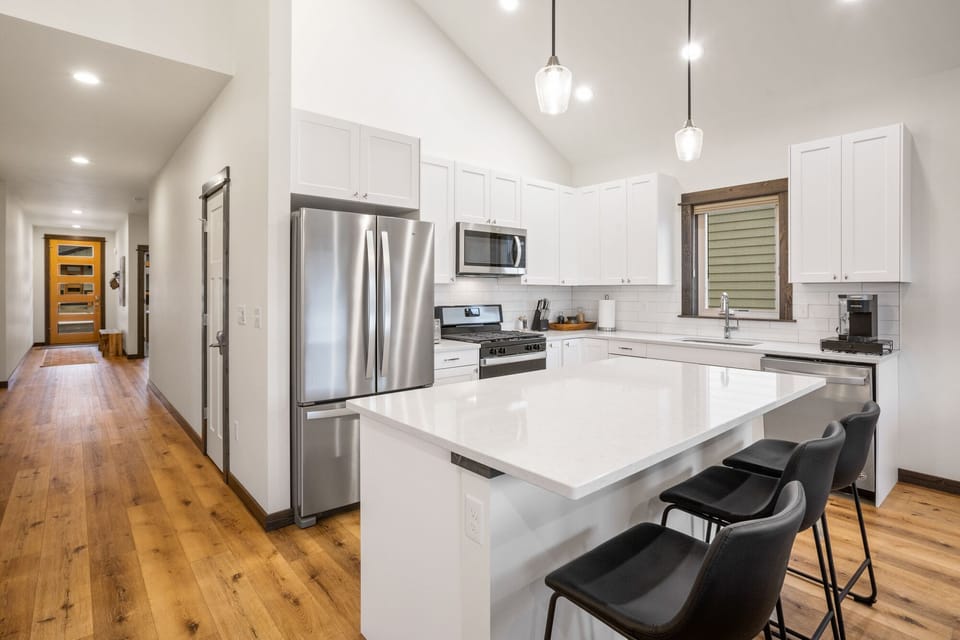 The kitchen is equipped with an electric range and oven, refrigerator, microwave, and all the necessary cookware needed.