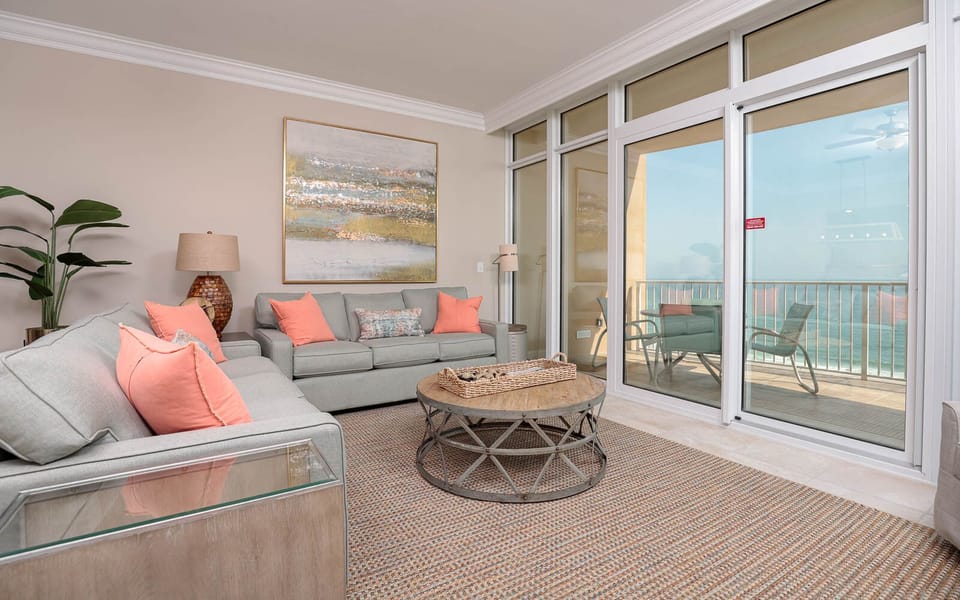 Relax in the inviting living area, enjoying the coastal breeze and views right from the sofas, featuring a queen sleeper