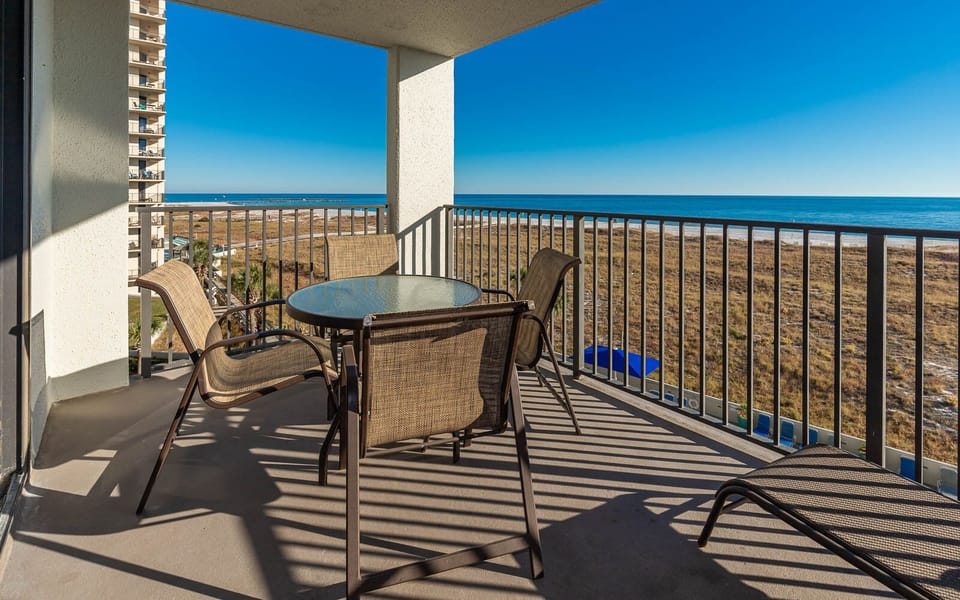 Balcony seating offers a serene view of the gulf and beach, perfect for relaxing in the warm sun