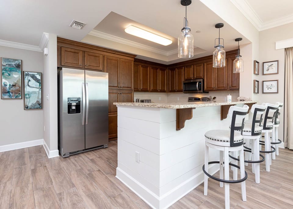 Sip your morning coffee at the breakfast bar and get ready for a beach day in this stylish space