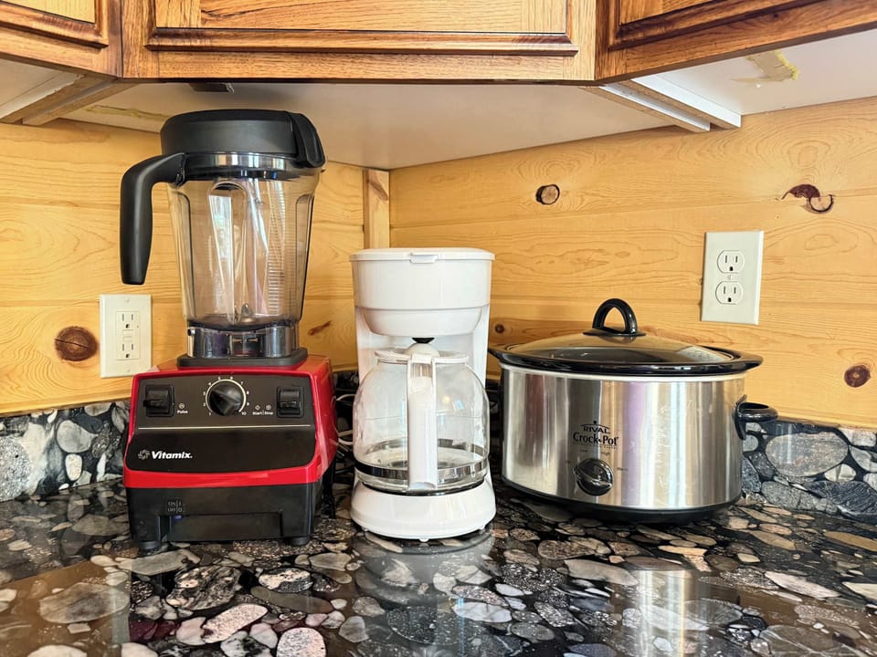 For your cooking convenience, the kitchen comes fully stocked with premium small appliances, including a high-powered Vitamix blender, a drip coffee maker, and a slow cooker.