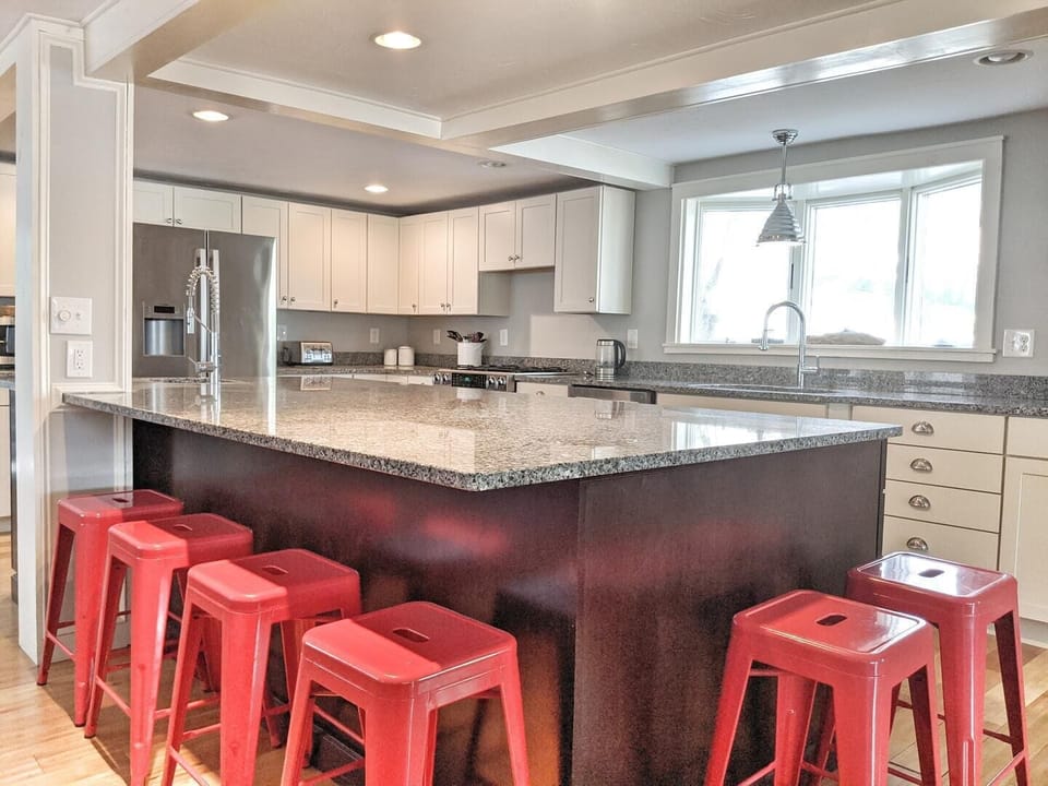 The kitchen island offers seating and a large area to prep your meals