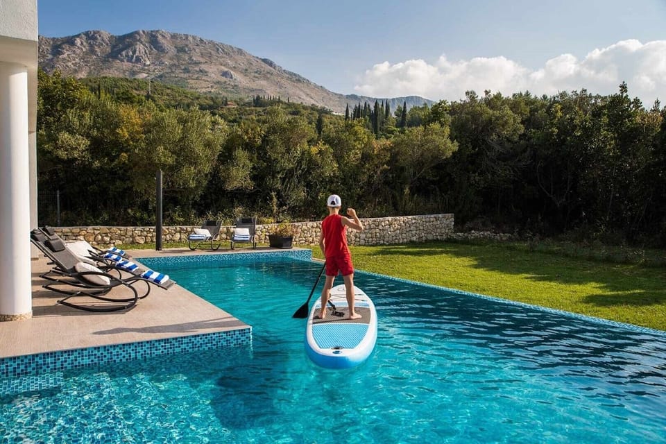 Stand-Up Paddling in a private pool on the terrace of a luxury Croatia family holiday villa near Dubrovnik