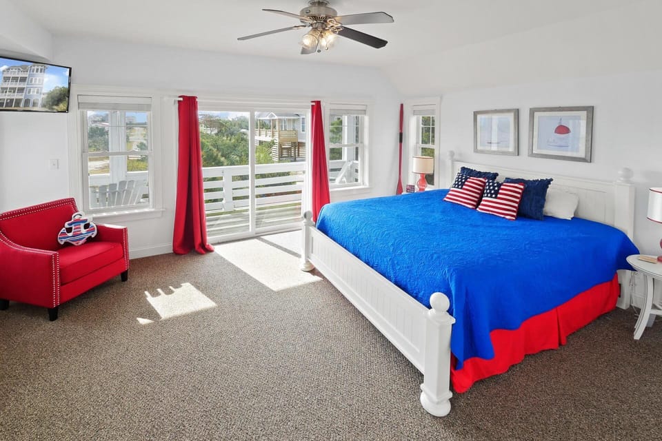 This second level king master bedroom features a private balcony, ensuite bathroom, and smart TV.