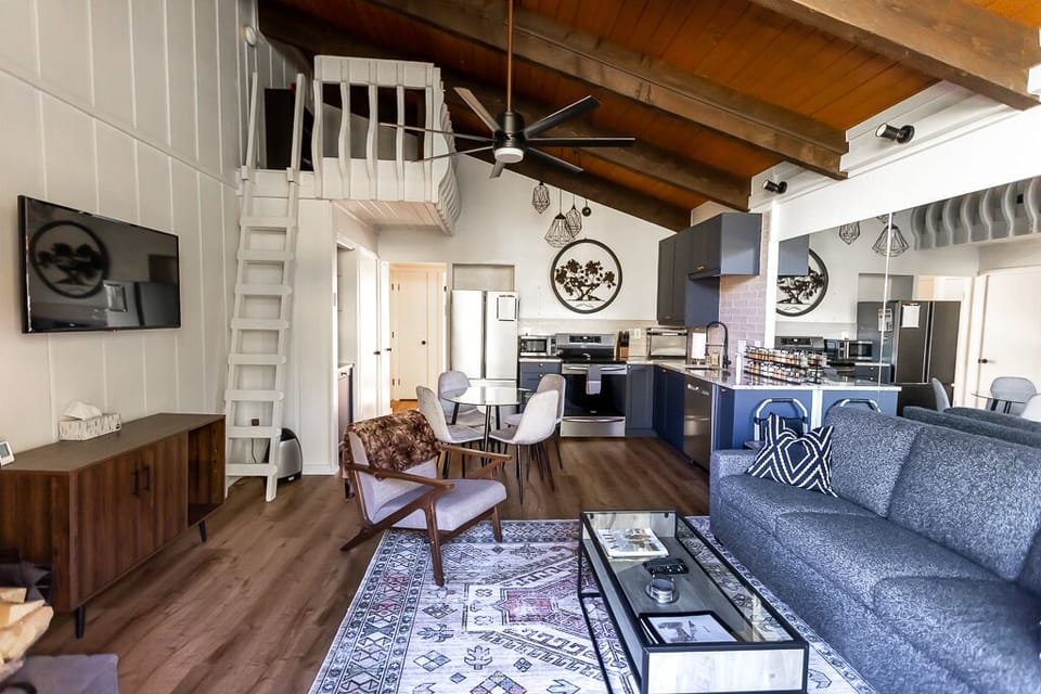 Cozy living space with fireplace, smart TV, and modern mountain charm.