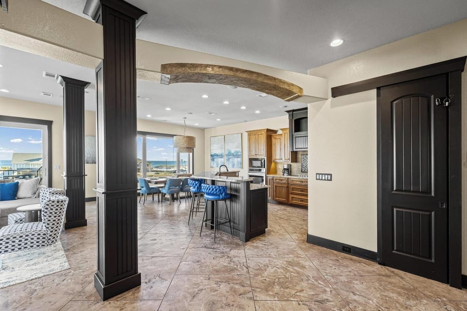 Step into your elegant open-concept haven where rustic stone arches meet modern luxury, perfect for gathering with loved ones.
