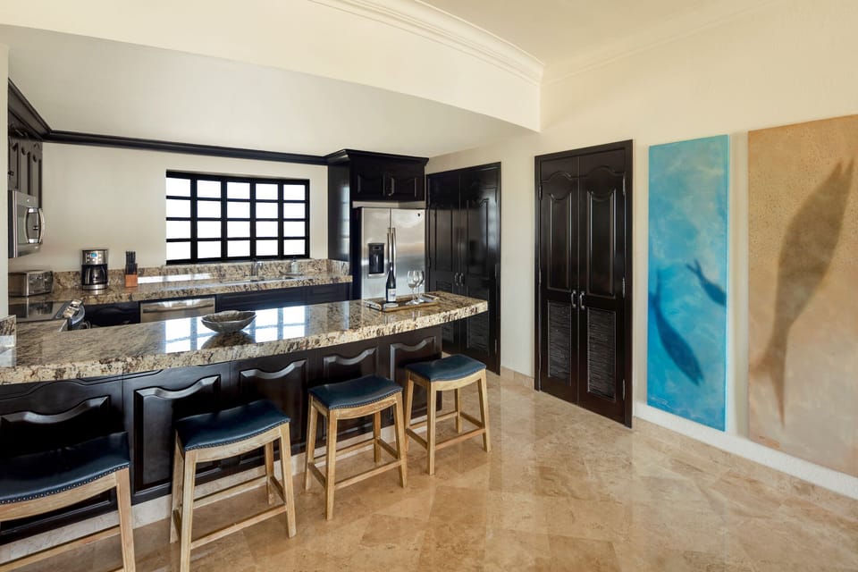 Beautifully appointed kitchen with granite and stainless steel appliances