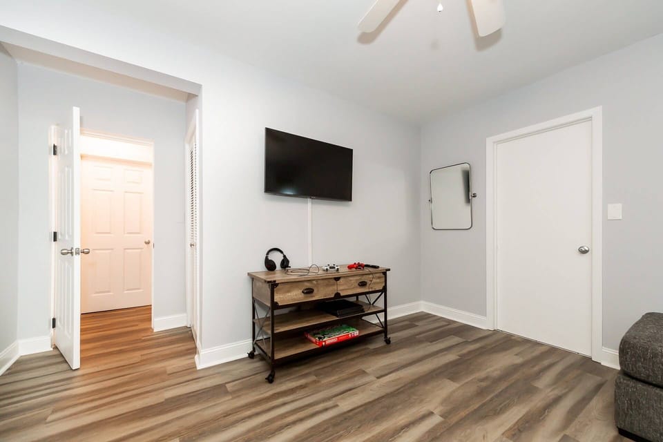 The downstairs area offers a large TV and a Play Station 4 with preloaded games and headphones