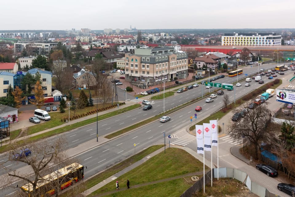 A panoramic shot of a city intersection with well-maintained roads and urban infrastructure.
