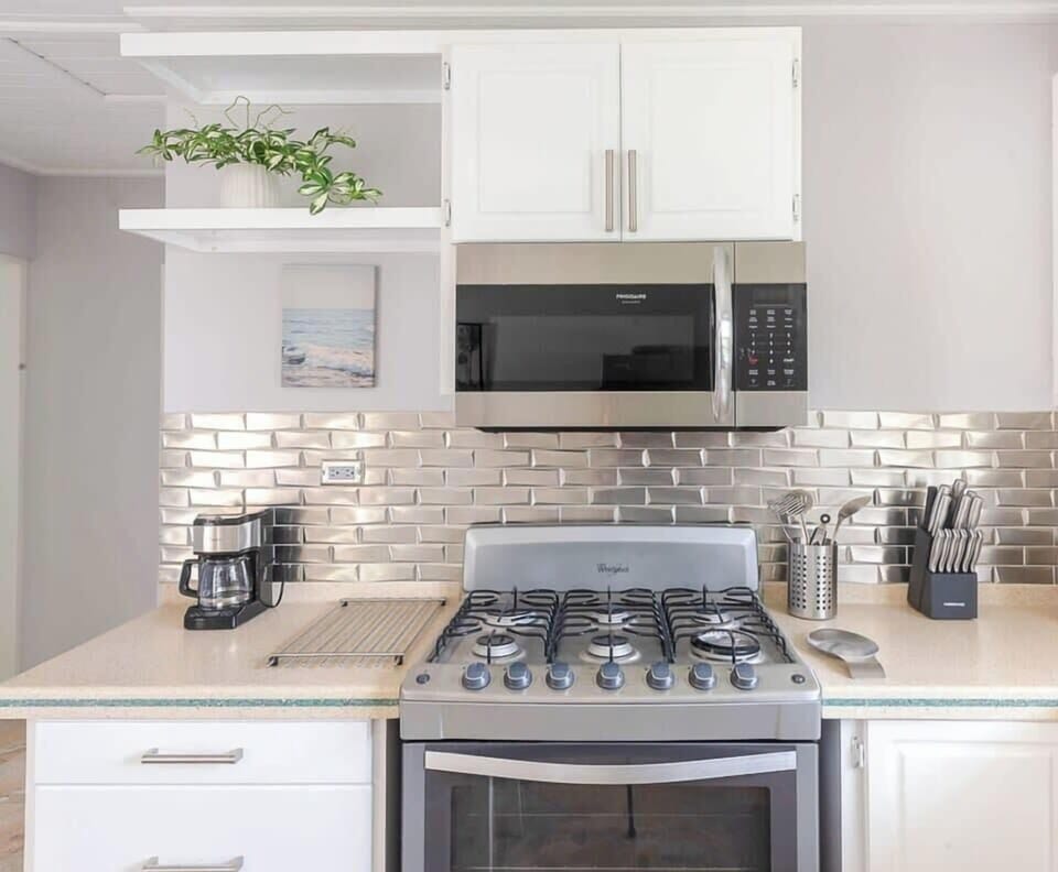 Enjoy the sleek new tile backsplash and high-quality appliances.