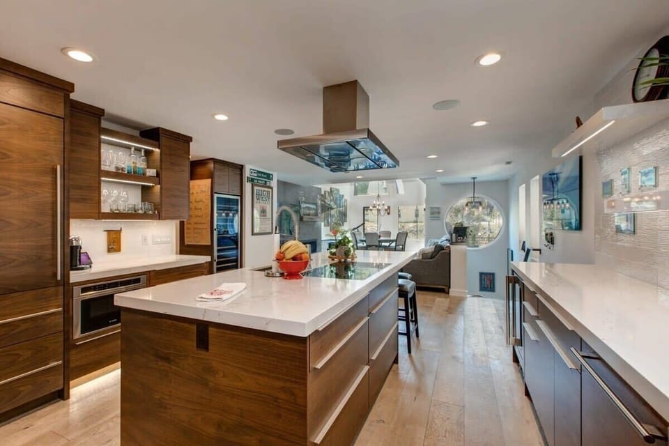 The kitchen features ample counter space, a large island with seating and elegant finishes make for a gorgeous kitchen.