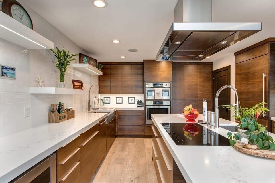 The kitchen features ample counter space, a large island with seating and elegant finishes make for a gorgeous kitchen.