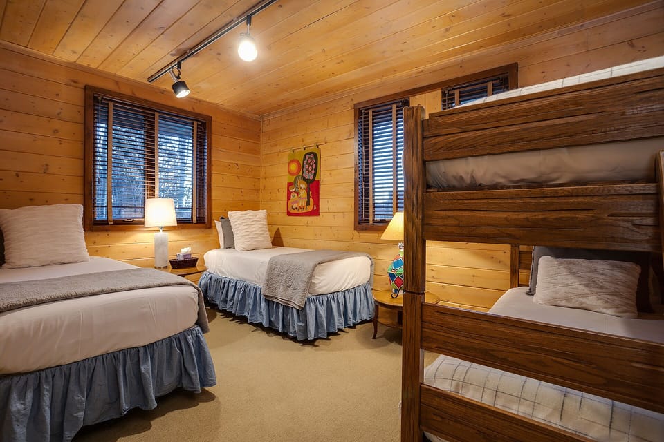 Gather everyone in your cozy log cabin retreat with two plush beds plus bunk-style sleeping—perfect for families or groups seeking warmth and rustic charm.