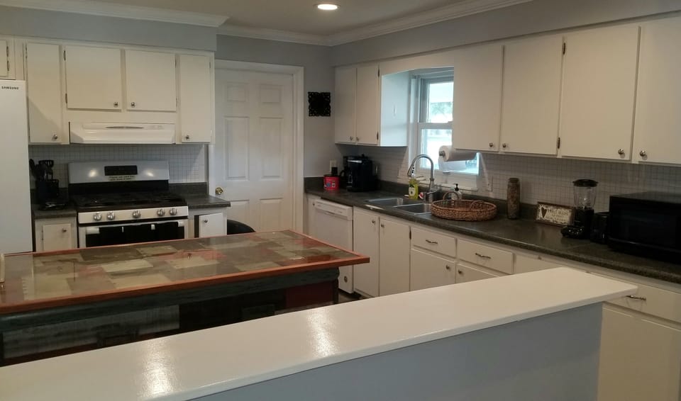Large kitchen stocked with appliances & wares for cooking and dining w/ family