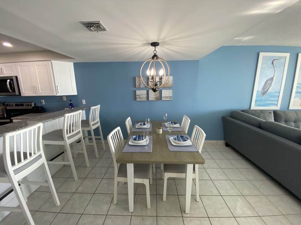 Table easily seats four can accommodate 6 and 3 more at the kitchen bar. 