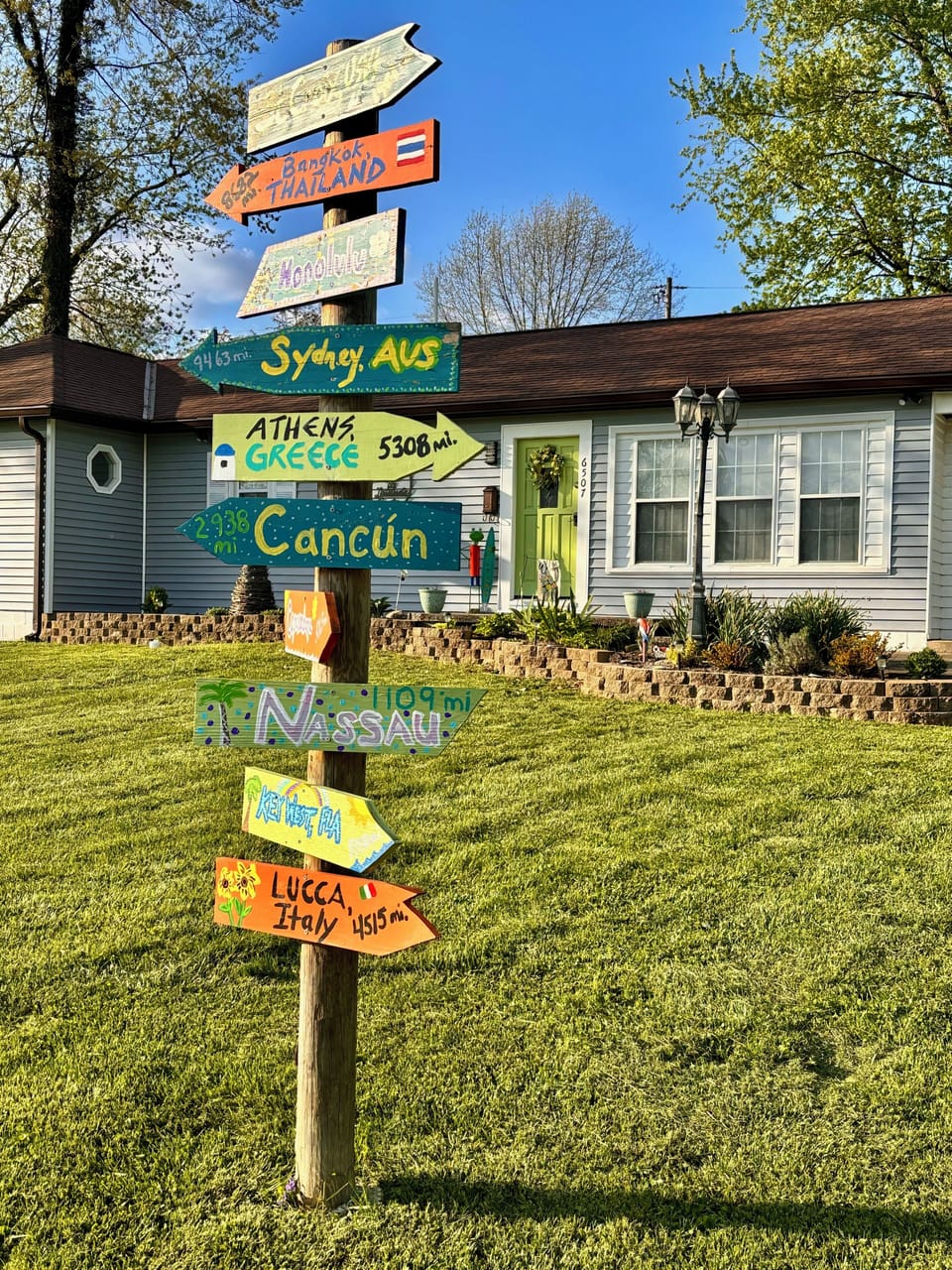 Front of house with fun directional sign