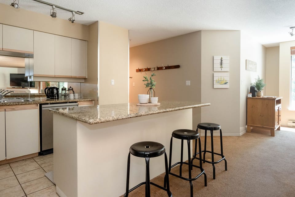 large kitchen with island and dining table, dishwasher