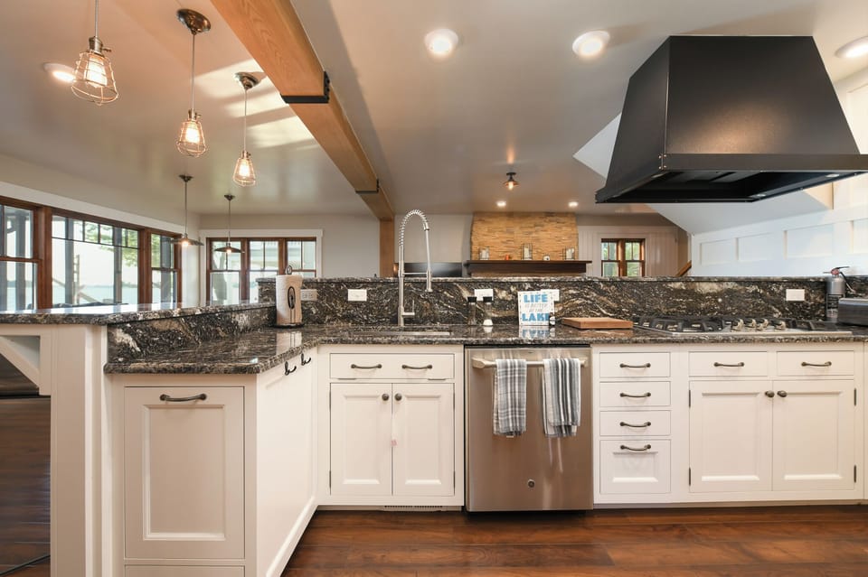Gourmet chefs kitchen with high end quartz counter tops and appliances.