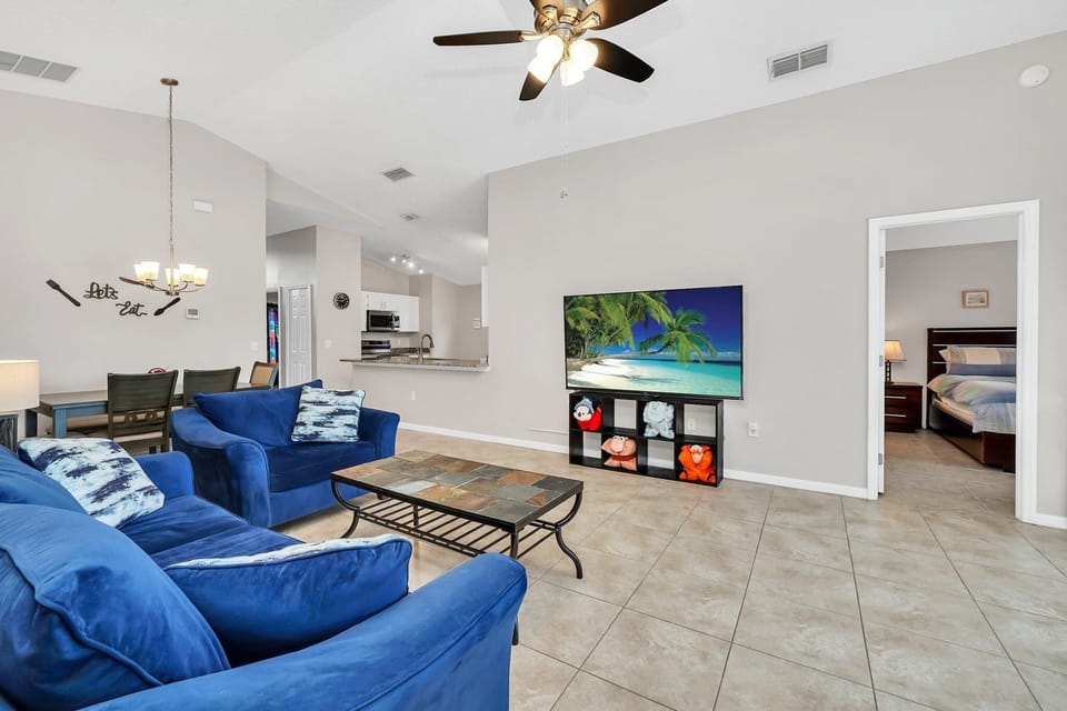 Comfortable furniture in main family area with a 75" flat screen TV