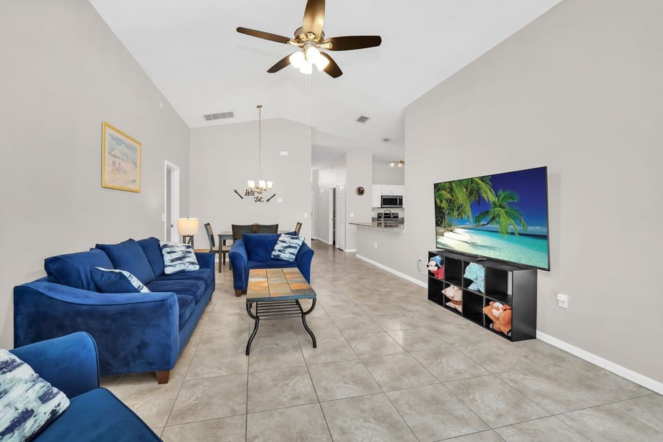 Comfortable furniture in main family area with a 75" flat screen TV