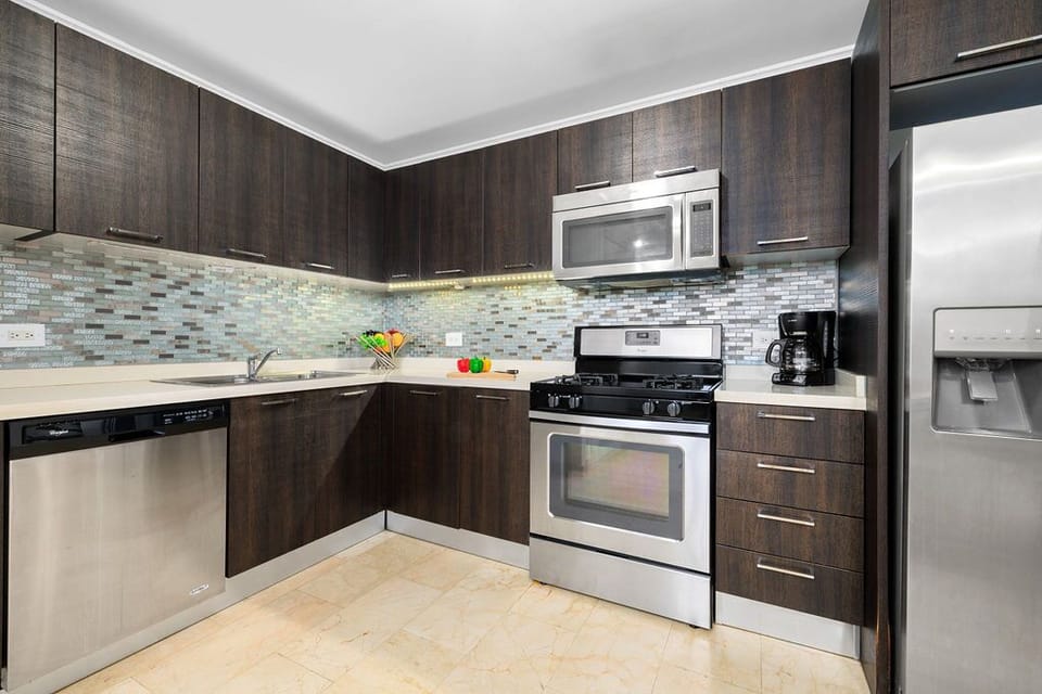 Open dining table and kitchen for 6. Fully functional kitchen complete with stove, microwave, and refrigerator.