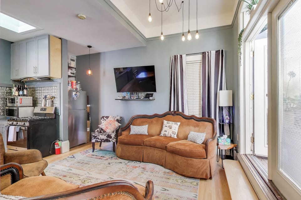 Spacious living room section of open concept living/dining/kitchen area