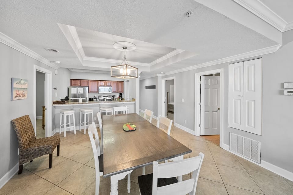 Gather around your elegant dining table beneath beautiful coffered ceilings, with the fully equipped kitchen just steps away for easy entertaining.