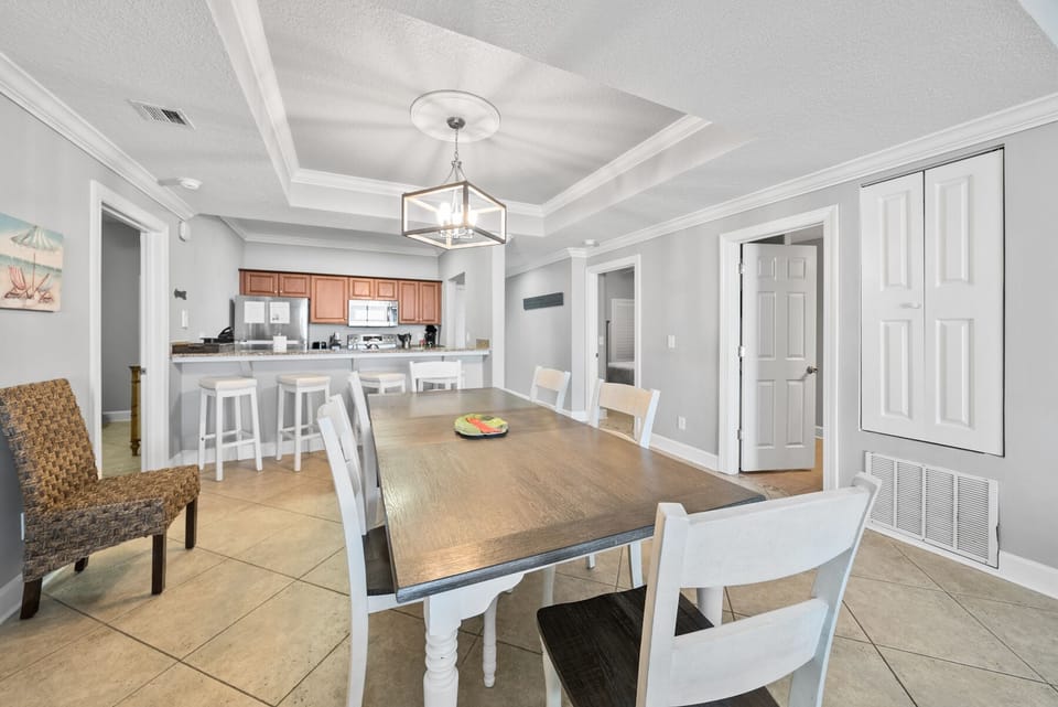 Gather around your spacious dining table for memorable meals, with an elegant chandelier overhead and open kitchen perfect for easy entertaining.
