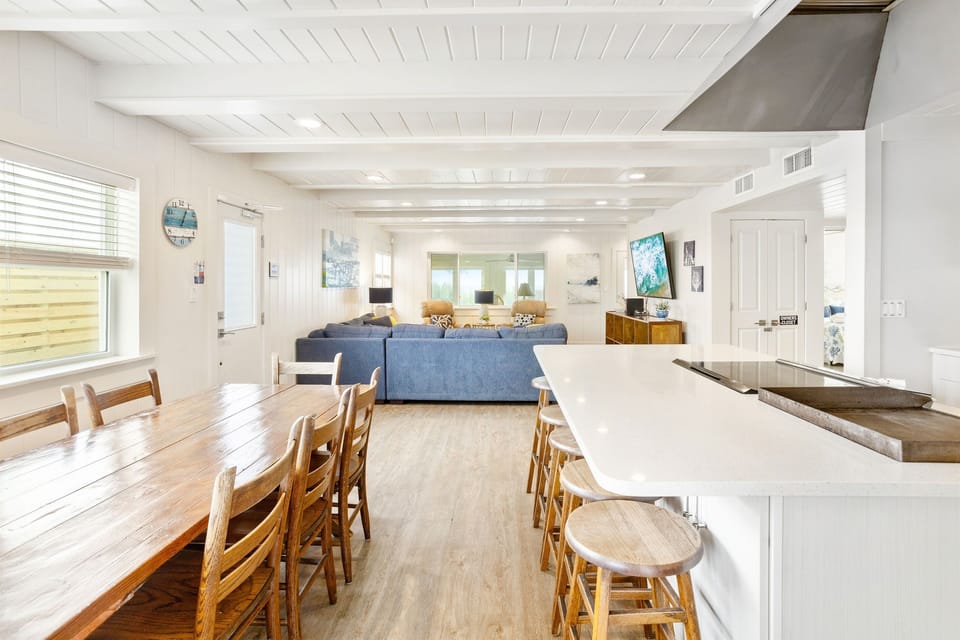 Gather around this beautiful open-concept space where your kitchen island becomes the heart of conversation and coastal dining table seats everyone.