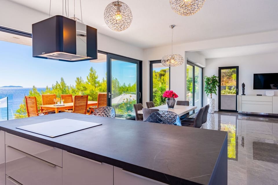 Kitchen island in fully equipped kitchen and dining area in luxury villa Blue Planet
