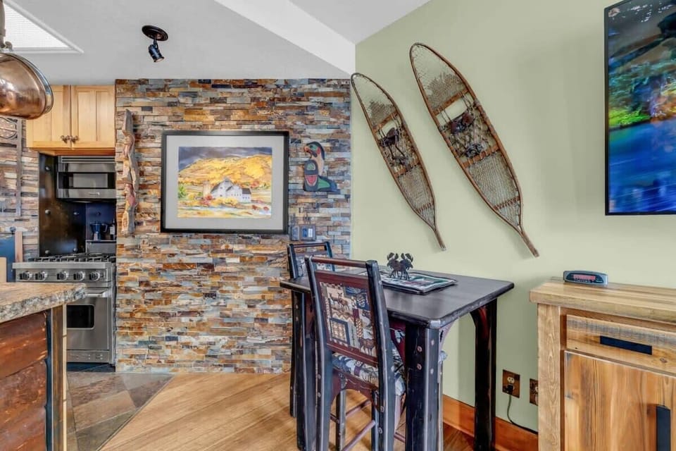 Centrally located between the kitchen and the living room is the dining area where you will find a tall table with seating for two.