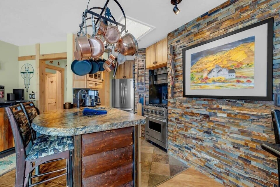 The fully equipped kitchen boasts a great layout with modern stainless steel appliances and a breakfast bar.