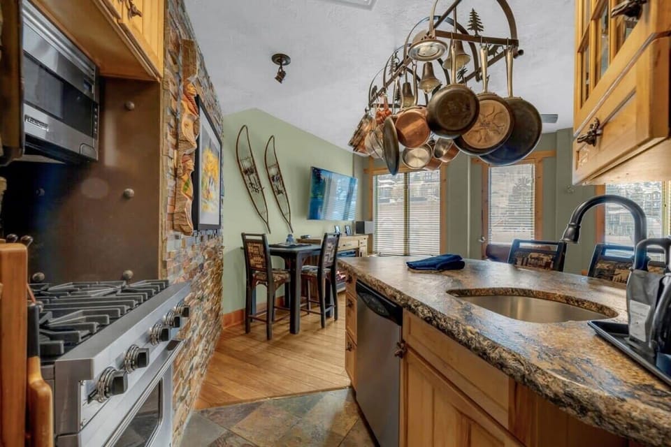 The fully equipped kitchen has everything you need to prepare delicious meals at home and includes both a breakfast bar and a dining table providing ample seating.